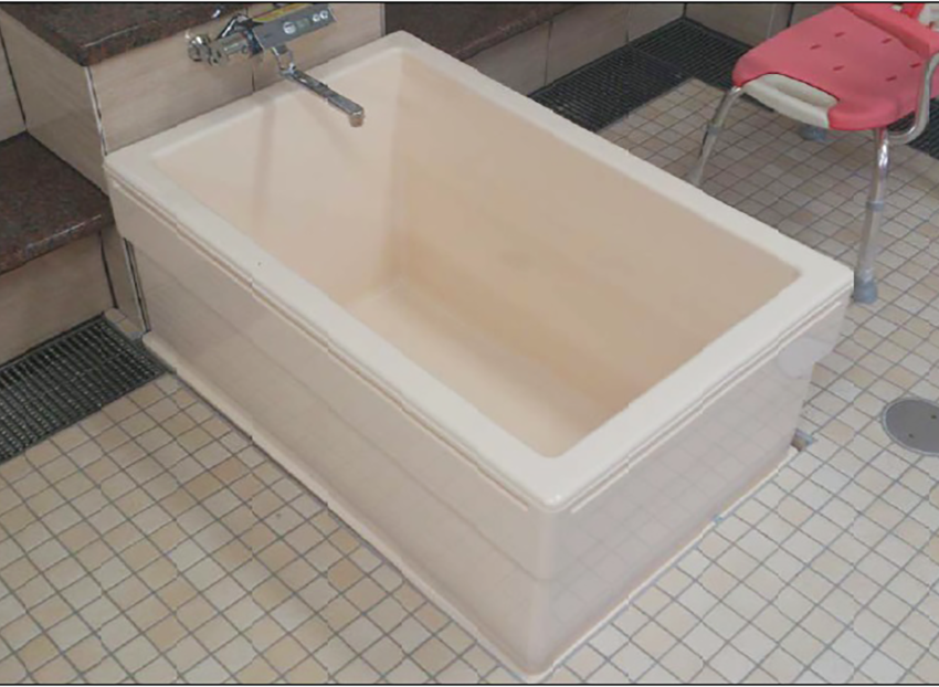 介護リフトと吊り具を使用しトイレベッドへ移乗